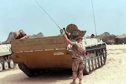 Two US Marines lower the trim vane on the front of an Iraqi BMP-1 captured during Operation Desert Storm, March 1991.