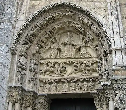 West portal, tympanum of left door. It depicts Christ on a cloud, supported by two angels, above a row of figures representing the labours of the months and signs of the Zodiac[34]