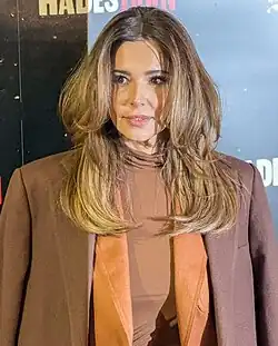 Cheryl wears an orange suit