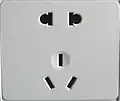 Chinese dual socket accepting both unearthed two-pin (upper) and earthed three-pin (lower) plugs