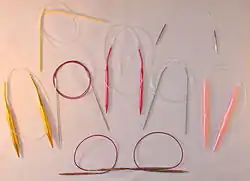 Circular knitting needles in different lengths, materials and sizes, including plastic, aluminum, steel and nickel-plated brass