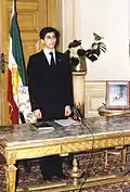 Reza Pahlavi, Crown Prince of Iran being sworn in with the Lion and Sun flag behind him