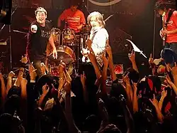 Johnny Gioeli and Jun Senoue performing live to a crowd