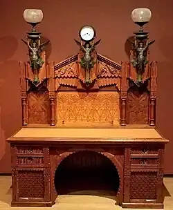 Desk; designed by Frank Furness, made by Daniel Pabst; 1870–1871; walnut, walnut veneer, rosewood (knobs), brass, iron, steel and glass; 196.9 × 157.5 × 81.9&nbsp;cm; Philadelphia Museum of Art (Philadelphia, USA)[67]