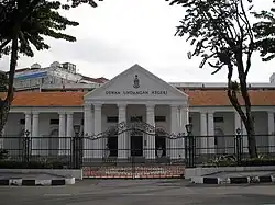 The front façade of the Penang State Assembly Building features columns supporting the pediment atop the portico.