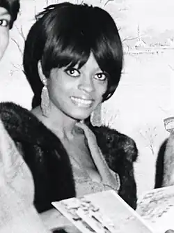 Black and white photo of Diana Ross with a somewhat awkward smile