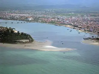 Aerial view of the city with Nhật Lệ River flow into its mouth at South China Sea