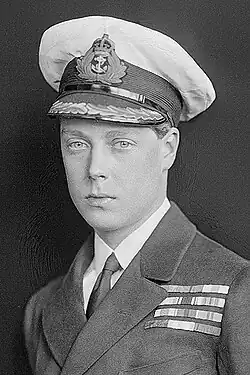 A close black-and-white portrait photograph of Edward VIII looking at the camera; he is in a suit with a navy cap and navy medals on the left side of his blazer