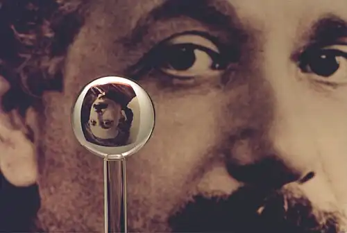 An image of one of the most accurate human-made spheres, as it refracts the image of Einstein in the background. This sphere was a fused quartz gyroscope for the Gravity Probe B experiment, and differs in shape from a perfect sphere by no more than 40 atoms (less than 10&nbsp;nm) of thickness. It was announced on 1 July 2008 that Australian scientists had created even more nearly perfect spheres, accurate to 0.3&nbsp;nm, as part of an international hunt to find a new global standard kilogram.[21]