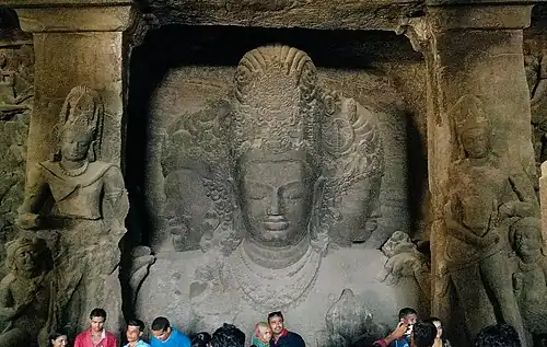 Elephanta Caves, triple-bust (trimurti) of Shiva, 18 feet (5.5&nbsp;m) tall, c. 550