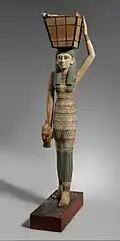 Figurine of a female servant carrying provisions; 1981–1975&nbsp;BC; painted wood and gesso; 112 × 17&nbsp;cm; Metropolitan Museum of Art (New York City)