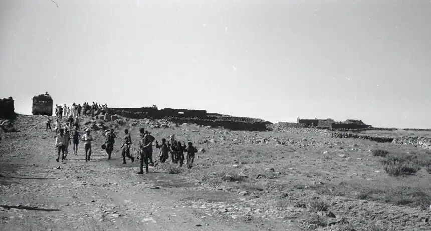 Forced transfer and displacement. Syrian civilians, hands raised, before Israeli soldiers, leave their homes in the Golan Heights