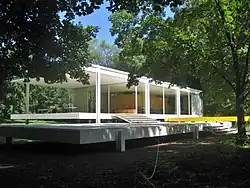View of the Farnsworth House from the southwest, behind the terrace and some trees