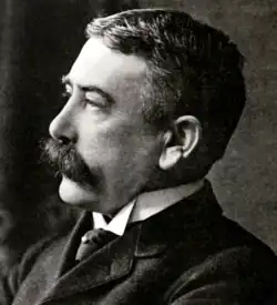 Black-and-white photo of a man with a moustache
