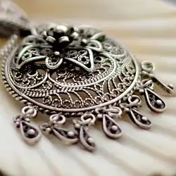 This photo taken with the lens aperture wide open resulting in a narrow depth-of-field and strong axial CA. The pendant has purple fringing in the near out-of-focus area and green fringing in the distance. Taken with a Nikon D7000 camera and an AF-S Nikkor 50&nbsp;mm f/1.8G lens.