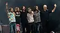 Foo Fighters after performing in June 2018. From left to right: Chris Shiflett, Taylor Hawkins, Dave Grohl, Nate Mendel, Rami Jaffee, and Pat Smear.
