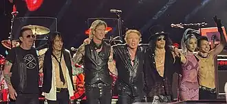 Guns N' Roses at Usce Park, Belgrade in 2025. From left to right: Dizzy Reed, Richard Fortus, Duff McKagan, Axl Rose, Slash, Melissa Reese and Isaac Carpenter.