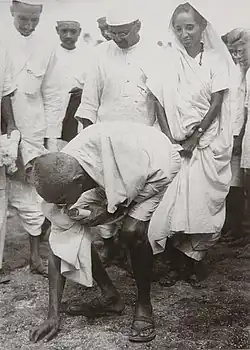 Mahatma Gandhi picking salt at Dandi beach, South Gujarat, ending the Salt satyagraha on 5 April 1930