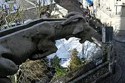 A gargoyle on the Basilique du Sacré-Cœur, Paris, France, showing the water channel