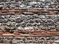 Close-up of the wall of the Roman shore fort at Burgh Castle, Norfolk, showing alternating courses of flint and brick