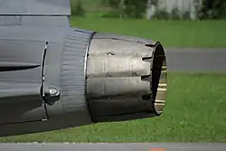 Side-view of circular aircraft engine exhaust nozzle, showing two distinct layers