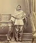 Sindhi girl from Karachi, Sind, in Sindhi ghagho like cholo and narrow suthan, c. 1870