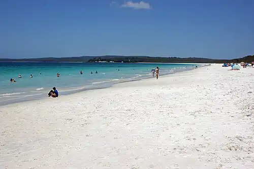Hyams Beach, New South Wales appears white because the sunlight is reflected or scattered by the quartz or limestone sand