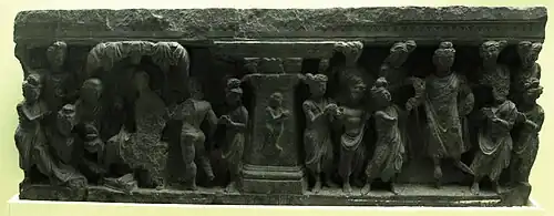 Relief with child depicted at the center, and numerous figures at the sides, including the Buddha