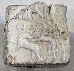 Fighting scene between a beast and a man with horns, hooves and a tail, who has been compared to the Mesopotamian bull-man Enkidu.[69][70][71] Indus Valley Civilisation seal.