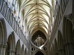 an interior view of the nave at Wells as described in the text. The nave terminates abruptly in a structure known as St Andrew's Cross, which was inserted to support the tower.