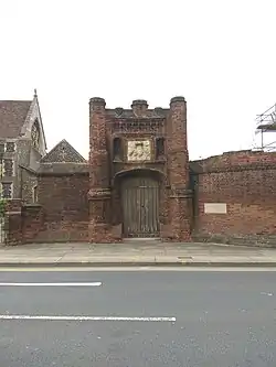 A Tudor gateway made from worn brick and stone