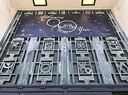 Ironwork above the entrance and below a sign marking the Observatory's 90th anniversary