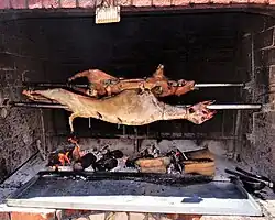 Spit-roasting a lamb and a suckling pig
