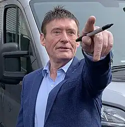 Jimmy White holding a pen and pointing