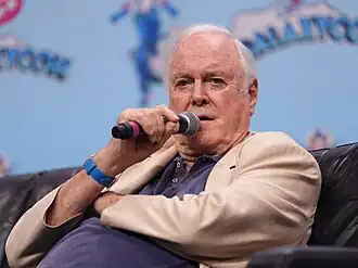 Cleese with a microphone