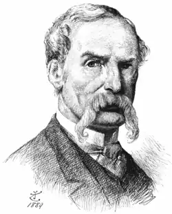 Middle-aged white man with full head of grey hair and large grey walrus moustache