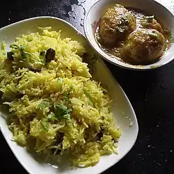 Pulao served alongside eggs in gravy