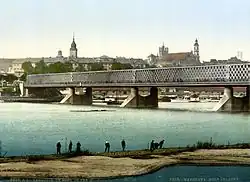 Kierbedź Bridge over the Vistula in Warsaw (c.&nbsp;1900). This framework bridge was constructed by Stanisław Kierbedź in 1850–1864. It was destroyed by the Germans in 1944.[50]