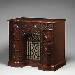 Kneehole writing table; circa 1760; mahogany, mahogany veneer and gilt bronze; 88.9 × 97.8 × 62.2&nbsp;cm; Metropolitan Museum of Art (New York City)