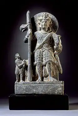 Kumara or Kartikeya with a Kushan devotee, c. 2nd century CE.