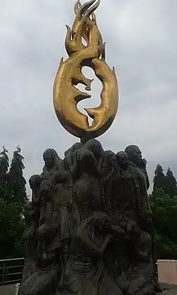 a memorial with sculpture of children and parents