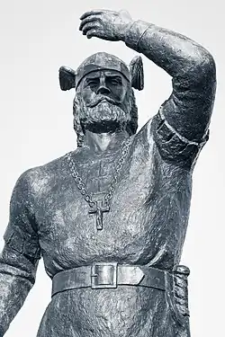 Statue of Leif Erikson standing with one arm raised, holding a staff