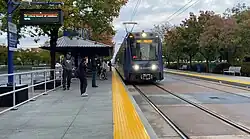 A blue light rail train pulling into Mather Field/Mills station.
