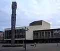 Pfalzbau concert hall and theater. In the foreground: "Pfalzsäule" (Palatinate Column, 1968), by the Munich artist Blasius Spreng and the local artist Ernst W. Kunz.