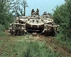 A remotely controlled Panther armoured mine clearing vehicle leads a column down a road in Bosnia and Herzegovina, 16 May 1996.