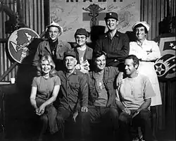 The cast from Season 6, 1977 (clockwise from left): William Christopher, Gary Burghoff, David Ogden Stiers, Jamie Farr, Mike Farrell, Alan Alda, Harry Morgan, Loretta Swit.