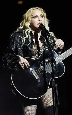 Madonna standing behind a microphone