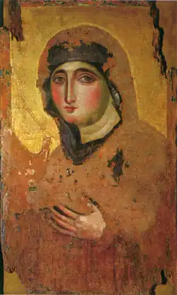 Slightly faded painting of a woman wearing a black veil, staring out of the portrait. Her hands are raised. The image is on a gold background.