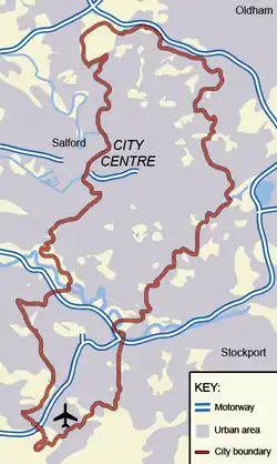A map showing the boundary of the City of Manchester with the City Centre, Salford, and the airport also labelled. Almost all of the map, both inside and outside of the boundary, is shaded in grey, which denotes urban sprawl.