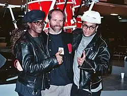 Fab Morvan (left) and Rob Pilatus (right) with NARAS president Mike Green, 1990